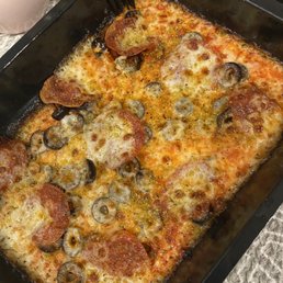 a pizza in a pan with a fork