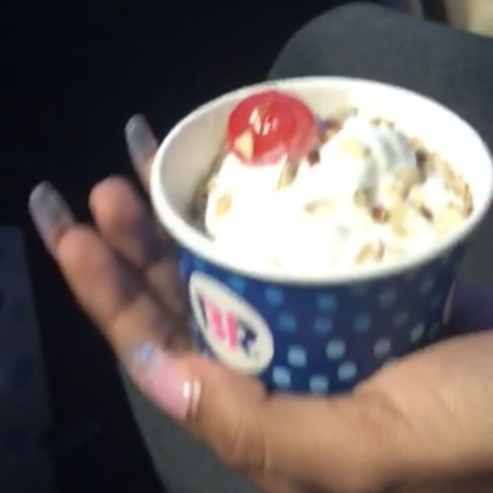 a hand holding a cup of ice cream a hand holding a cup of ice cream
