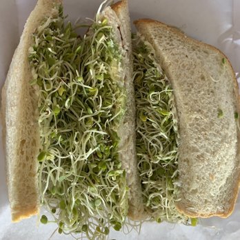 Diggers Deli - a sandwich with sprouts and a knife - Delis Near Me - Vacaville, California