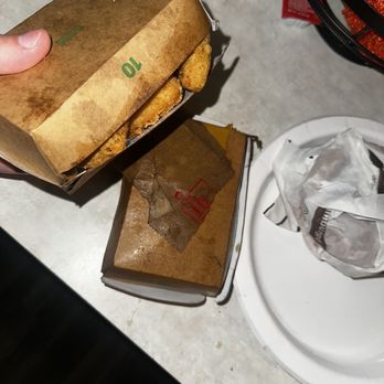 McDonald's - a person holding a box of food - Burgers Near Me - Belleville, Michigan McDonald's - a person holding a box of food - Burgers Near Me - Belleville, Michigan