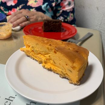Bruce's Fabulous Foods - Main Street Mango Cheesecake, with chunks of mango, as good as it sounds. Brownie in the background. - Southern Near Me - Marion, North Carolina
