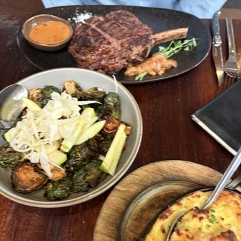 Black Cow Chophouse - Fried Brussels Sprouts, Whipped Golden Potatoes, Cowboy Ribeye (cooked medium) with Cognac Peppercorn sauce on side - Steakhouses Near Me - Charlottesville, Virginia
