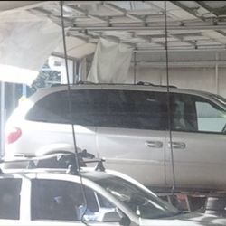 Les Schwab Tire Center - Here Les Schwab is lifting my minivan directly from the stow n go boxes, and will do a lot of damage without telling me.