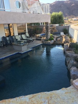 Photo of Lifeguard Pools - Las Vegas, NV, US. Spa holds 14 people and has a stream that flows down into the pool, plus the waterfall in the spa itself.