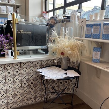 Le Marais Bakery - Barista stand at the entrance with fresh purple flowers. - Coffee & Tea Near Me - Mill Valley, California