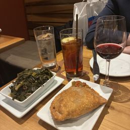Greens, crawfish pie, wine