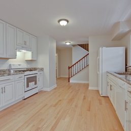 a clean kitchen with white cabinets