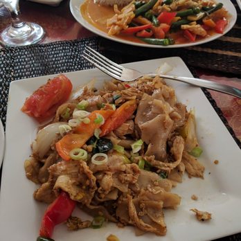 Thai Charm Restaurant - Drunken Noodles.... notice the huge chunk of tomato on the top left corner of the plate. That's is literally one half of a tomato. - Thai Near Me - New Milford, Connecticut Thai Charm Restaurant - Drunken Noodles.... notice the huge chunk of tomato on the top left corner of the plate. That's is literally one half of a tomato. - Thai Near Me - New Milford, Connecticut