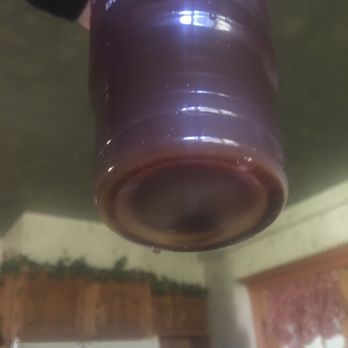 Dunkin' -  a person holding a large jug in a kitchen - Donuts Near Me - Hamilton, New Jersey