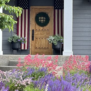 Garden Landscapes - a house with a flag on the front door - Landscaping Near Me Garden Landscapes - a house with a flag on the front door - Landscaping Near Me