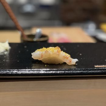 Zen Sushi Omakase - a piece of sushi on a black plate - Sushi Bars Near Me - New York, New York Zen Sushi Omakase - a piece of sushi on a black plate - Sushi Bars Near Me - New York, New York