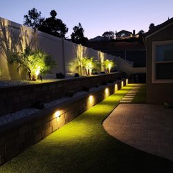 Eternal Turf & Pavers - "This project is a perfect example of a full yard remodel, featuring high-quality pavers, artificial turf, a retaining wall, and nighttime l