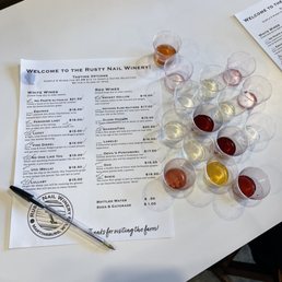 a table with a menu and glasses of wine a table with a menu and glasses of wine