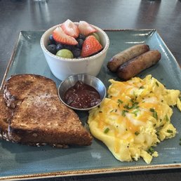 The traditional with scrambled eggs with cheese, sausage links, wheat toast and fresh fruit instead of potatoes