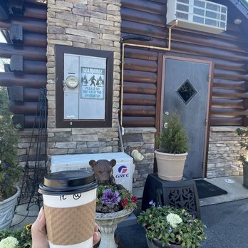 Coffee Lodge - a person holding a cup of coffee - Coffee & Tea Near Me - Rolesville, North Carolina