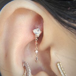 Deep Roots Tattoo & Body Piercing - Rook piercing with a threadless end and charm from Buddha Jewelry.