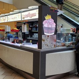 two people standing at a counter two people standing at a counter