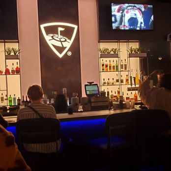 Topgolf - a man sitting at a bar - New American Near Me - mashantucket, Connecticut