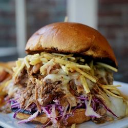 Eddie's Roadhouse - Ultimate Pulled Pork Sandwich 
smoked & braised pork shoulder | pepper jack cheese | potato stix | chipotle slaw