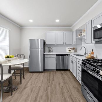 Sunset Heights - A kitchen with white cabinetry and stainless steel appliances - Apartments Near Me - San Antonio, Texas Sunset Heights - A kitchen with white cabinetry and stainless steel appliances - Apartments Near Me - San Antonio, Texas
