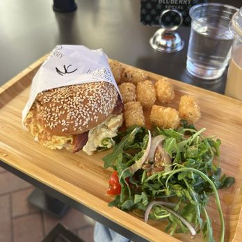 Bluberry Social - Early Bird Egg Sandwich with super crispy tots and a delicious arugula salad on the side - Breakfast & Brunch Near Me - Irvine, California Bluberry Social - Early Bird Egg Sandwich with super crispy tots and a delicious arugula salad on the side - Breakfast & Brunch Near Me - Irvine, California