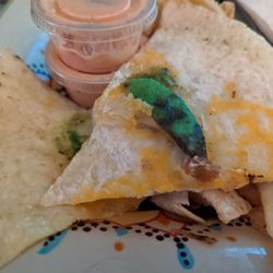 Super Mega Dilla - The cheesy chicken - sparse cheese, no chicken, and avocados that were not ordered. This is 1/3 of the burrito.