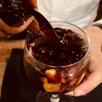 Meson Ria De Vigo - a person pouring a drink - Spanish Near Me - Miami, Florida Meson Ria De Vigo - a person pouring a drink - Spanish Near Me - Miami, Florida