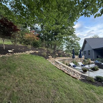 Mateo's Construction and Landscaping - They added the sod, built up the hill, fixed soil erosion by building this river drain, landscaping in front and built the patio. - Landscaping Near Me Mateo's Construction and Landscaping - They added the sod, built up the hill, fixed soil erosion by building this river drain, landscaping in front and built the patio. - Landscaping Near Me
