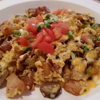 Nick's West Side - Scramble. Made with eggs, bacon, sausage, cheddar, bell peppers and tomatoes, served with your choice of toast. Very delicious! - Breakfast & Brunch Near Me - Sedona, Arizona Nick's West Side - Scramble. Made with eggs, bacon, sausage, cheddar, bell peppers and tomatoes, served with your choice of toast. Very delicious! - Breakfast & Brunch Near Me - Sedona, Arizona