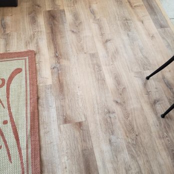 Hyatt Flooring - a hardwood floor with a rug - Flooring Near Me