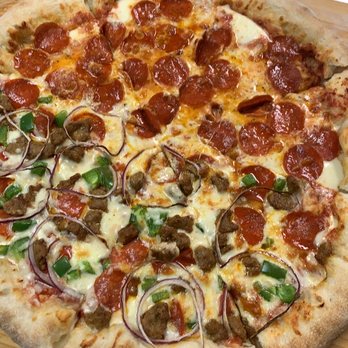 MoMo's Cafe - a pepperoni pizza on a cutting board - Food Trucks Near Me - Lansing, New York