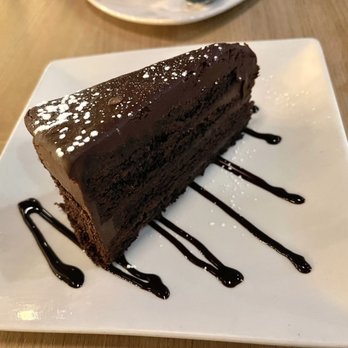 The Kouzzina - a piece of chocolate cake on a plate - Italian Near Me - Sudbury, Ontario The Kouzzina - a piece of chocolate cake on a plate - Italian Near Me - Sudbury, Ontario