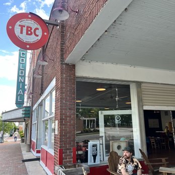 Tarboro Brewing - a woman sitting at a table outside a restaurant - Brewpubs Near Me - Tarboro, North Carolina