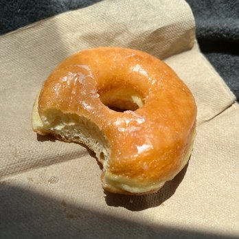 Trojan Donuts - a half eaten doughnut on a napkin - Donuts Near Me - Troy, Alabama Trojan Donuts - a half eaten doughnut on a napkin - Donuts Near Me - Troy, Alabama