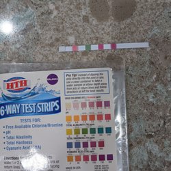 Orange Leaf Pool Care - Test strip showing 0 chlorine and pH over 8.