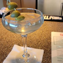 a martini with olives in it a martini with olives in it