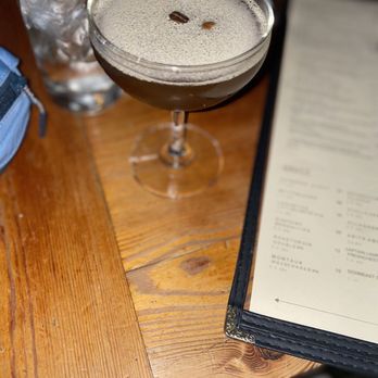 The Milton - a drink on a table with a menu - Irish Near Me - New York, New York The Milton - a drink on a table with a menu - Irish Near Me - New York, New York