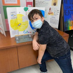 Courthouse Montessori School - Faris (2nd grade) with his gravity project for the science fair.