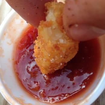 Kilkenny's Pub - a person dipping a piece of food into a bowl of ketchup - Pubs Near Me - Davenport, Iowa Kilkenny's Pub - a person dipping a piece of food into a bowl of ketchup - Pubs Near Me - Davenport, Iowa