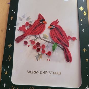 HomeGoods - It's the eyes that made me buy these. They hypnotized me!! - A set of four quilled Christmas cards displays two red cardinals on a branch with holly leaves, with a festive border and 'Merry Christmas' message. - Kitchen & Bath Near Me - Garrison, Maryland