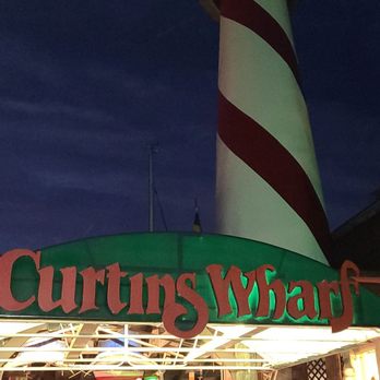 Curtin's Wharf Restaurant - a lighthouse at night - American Near Me - Burlington, New Jersey