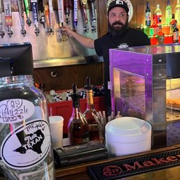 a bartender behind the bar a bartender behind the bar