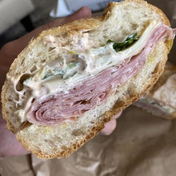 Little Vine - a person holding a half eaten sandwich - Cheese Shops Near Me - San Francisco, California Little Vine - a person holding a half eaten sandwich - Cheese Shops Near Me - San Francisco, California