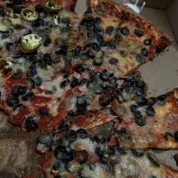 a pizza with olives and cheese