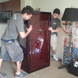 Ontrack Moving & Storage - "Professional movers carefully relocating a heavy safe using proper equipment and secure handling techniques.