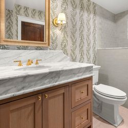 Dream Home Construction - Bellevue, WA | elegant guest bathroom remodel with custom vanity, raised marble counter top and handmade subway tiles by DHC 2025