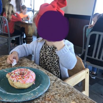 Missy's Doughnuts & Bakery - One of the grands enjoying her pink sprinkle donut - Donuts Near Me - Guthrie, Oklahoma