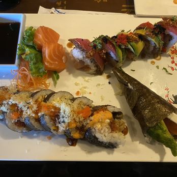 Tsukiji Fusion Sushi - Katy - Front right: Salmon hand roll. Front left: Pixie Roll. Back left: 2 pieces of salmon sashimi. Back right: Hurricane roll. - Japanese Near Me - Katy, Texas