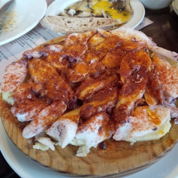 Las Tapas de Lola - Pulpo - Sliced tender octopus served on top of potatoes - Tapas Bars Near Me - Dublin, D Las Tapas de Lola - Pulpo - Sliced tender octopus served on top of potatoes - Tapas Bars Near Me - Dublin, D