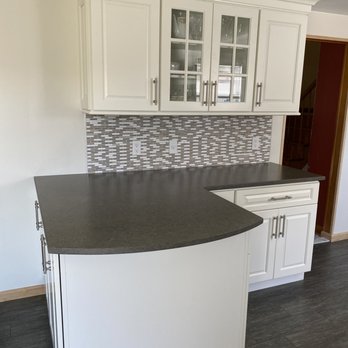 FRM Home Improvements - a kitchen with white cabinets - General Contractors Near Me - Coram, New York
